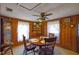 Dining room with wood paneling, round table, and windows bringing in natural light at 2948 Lenora Rd, Snellville, GA 30039
