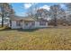 Single-story white house with a covered front porch and a large front yard at 2948 Lenora Rd, Snellville, GA 30039