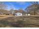 Backyard view with trees and additional buildings at 2948 Lenora Rd, Snellville, GA 30039