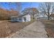 Home exterior with concrete driveway and trees at 2948 Lenora Rd, Snellville, GA 30039