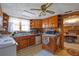 Dated kitchen with ample wood cabinetry, white appliances, and window over the sink at 2948 Lenora Rd, Snellville, GA 30039