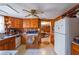 Kitchen with wood cabinets, white refrigerator, and view to dining area at 2948 Lenora Rd, Snellville, GA 30039