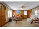 Living room with wood paneling, ceiling fan, and comfortable seating at 2948 Lenora Rd, Snellville, GA 30039
