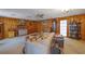 Living room with wood paneling, fireplace, sofas, and vintage accents at 2948 Lenora Rd, Snellville, GA 30039