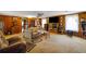 Living room with wood paneling, fireplace, and view into adjacent room at 2948 Lenora Rd, Snellville, GA 30039