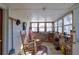 Sunroom with brick walls, rocking chairs, and large windows at 2948 Lenora Rd, Snellville, GA 30039