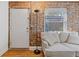 Living area features exposed brick wall and hardwood floors at 24 Daniel Se St # 12, Atlanta, GA 30312
