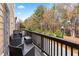 Private balcony with outdoor seating and views of the surrounding trees at 4192 Integrity Way, Powder Springs, GA 30127