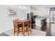 Dining area adjacent to the kitchen with hardwood floors and seating for four at 4192 Integrity Way, Powder Springs, GA 30127