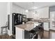 Modern kitchen with granite countertops, stainless steel appliances, and breakfast bar at 4192 Integrity Way, Powder Springs, GA 30127