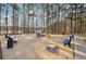 Community fire pit area with seating and cornhole, offering a relaxing lakeside view at 760 Woodrow Dr, Lawrenceville, GA 30043