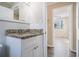 White bathroom vanity with granite countertop and view into adjacent room at 2631 Godfrey Nw Dr, Atlanta, GA 30318