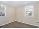 Empty bedroom with two windows, wood-look flooring, and neutral walls at 2631 Godfrey Nw Dr, Atlanta, GA 30318