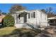 White brick exterior, black shutters, covered porch, and fenced backyard at 2631 Godfrey Nw Dr, Atlanta, GA 30318