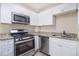 Modern kitchen with white cabinetry, stainless steel appliances, and granite countertops at 2631 Godfrey Nw Dr, Atlanta, GA 30318