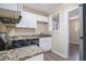 Updated kitchen featuring white cabinets, granite countertops, and stainless steel appliances at 2631 Godfrey Nw Dr, Atlanta, GA 30318