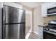 Kitchen boasts stainless steel appliances, white cabinets, and granite countertops at 2631 Godfrey Nw Dr, Atlanta, GA 30318