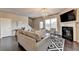 Living room with hardwood floors, fireplace, and access to deck at 1257 Park Pass Way, Suwanee, GA 30024