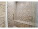 Large walk-in shower with tiled walls and built-in seat at 22 Spring Lake Trl, White, GA 30184