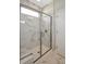 Large walk-in shower with marble tile and built-in seat at 5763 Grapewood St, Hoschton, GA 30548