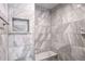 Clean and spacious shower with marble-style tiled walls and built-in seat at 2769 Peachtree Ne Rd # 10, Atlanta, GA 30305