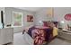 Bright bedroom with a floral comforter and large window at 3280 Greyton Dr, Buford, GA 30519