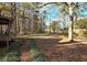 Spacious backyard with wooded area and walking path at 125 Toccoa Rd, Carrollton, GA 30116