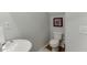 Small half bathroom with white pedestal sink and toilet at 510 Jefferson Chase St, Atlanta, GA 30354
