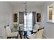 Charming dining room with glass table and four chairs, complemented by chandelier at 510 Jefferson Chase St, Atlanta, GA 30354