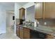 Galley kitchen with granite countertops and dark brown cabinets at 510 Jefferson Chase St, Atlanta, GA 30354