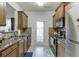 Galley kitchen with granite countertops and dark brown cabinets at 510 Jefferson Chase St, Atlanta, GA 30354
