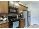 Galley kitchen with granite countertops and dark brown cabinets at 510 Jefferson Chase St, Atlanta, GA 30354