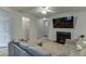 Bright living room with fireplace, sectional sofa, and views into hallway at 510 Jefferson Chase St, Atlanta, GA 30354