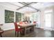 Dining room with red chairs, large wooden table, and unique overhead lighting at 2541 Kickerillo Se Way, Atlanta, GA 30316