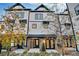 Two-story townhome with white siding, black accents, and landscaping at 2587 Ocean Walk Nw Dr, Atlanta, GA 30318