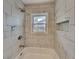 Updated bathroom with marble tile shower and built-in shelving at 1864 Pinedale Pl, Decatur, GA 30032