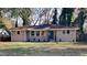Newly renovated ranch home with landscaped yard and a teal front door at 1864 Pinedale Pl, Decatur, GA 30032