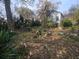 Large backyard with overgrown landscaping and debris at 43 Gammon Se Ave, Atlanta, GA 30315