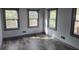 Spacious bedroom with three windows and grey laminate flooring at 43 Gammon Se Ave, Atlanta, GA 30315