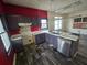 A galley kitchen with dark cabinets, laminate flooring, and stainless steel dishwasher at 43 Gammon Se Ave, Atlanta, GA 30315