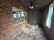 Sunroom with brick walls, tiled floor, and ceiling fan at 43 Gammon Se Ave, Atlanta, GA 30315