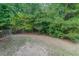 Wooded backyard with partially fenced area at 5439 Village Rdg, Fairburn, GA 30213