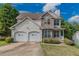 Two-story house with stone accents and a two-car garage at 5439 Village Rdg, Fairburn, GA 30213