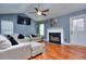 Living area with hardwood floors, sectional sofa, and fireplace at 75 Lumby Ln, Covington, GA 30016