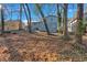 Spacious backyard with mature trees and a partially fenced area at 2080 Bluffton Way, Decatur, GA 30035
