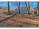 Spacious backyard with mature trees and a partially fenced area at 2080 Bluffton Way, Decatur, GA 30035