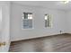 Well-lit bedroom featuring wood-look floors and two windows at 2080 Bluffton Way, Decatur, GA 30035