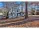 A light blue house nestled among tall trees in the yard at 2080 Bluffton Way, Decatur, GA 30035