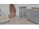 Modern kitchen with gray cabinets, granite counters and tile floors at 2080 Bluffton Way, Decatur, GA 30035