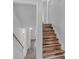 Modern staircase with wood-look flooring connecting the levels of the home at 2080 Bluffton Way, Decatur, GA 30035